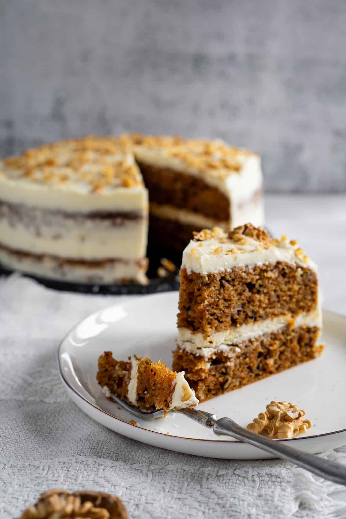 carrot cake on plate with fork