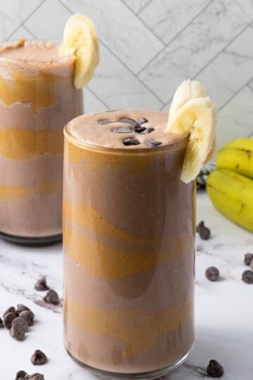 two glasses of chocolate peanut butter smoothie