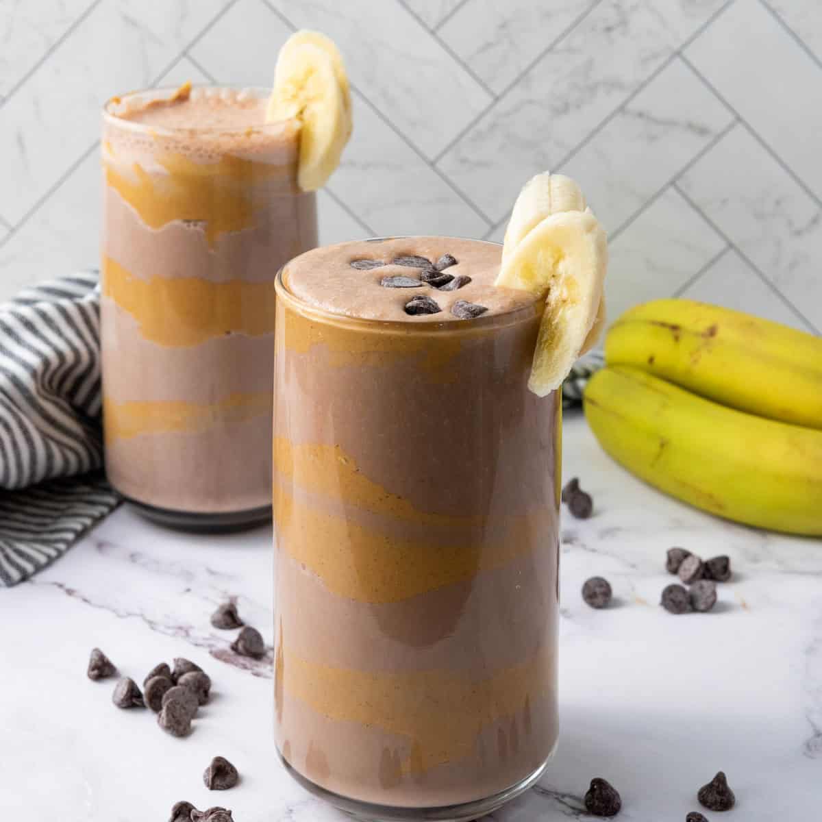 two glasses of chocolate peanut butter smoothie