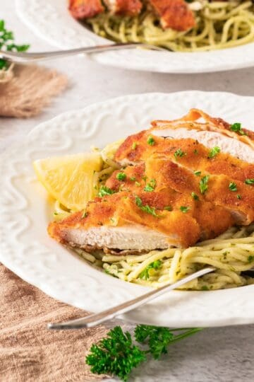 crispy lemon garlic chicken with spaghetti on plate