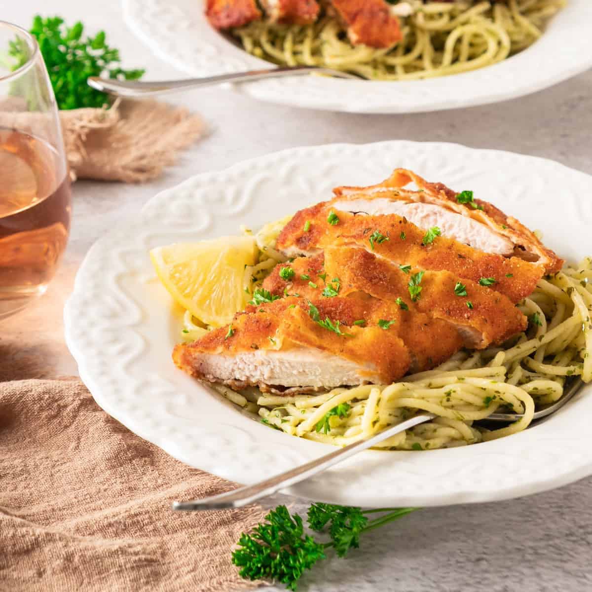 crispy lemon garlic chicken with spaghetti on plate