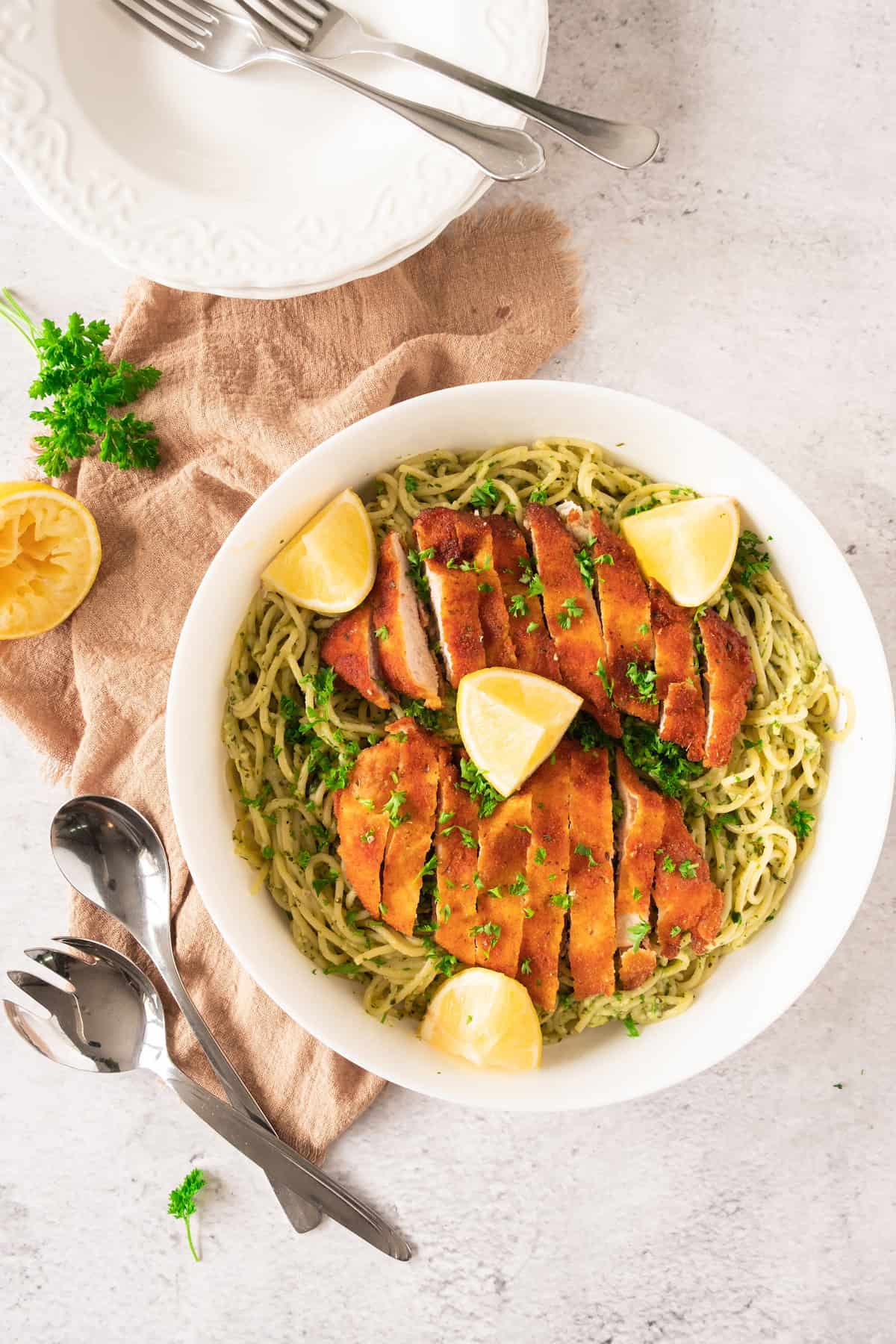 plate of chicken atop spaghetti