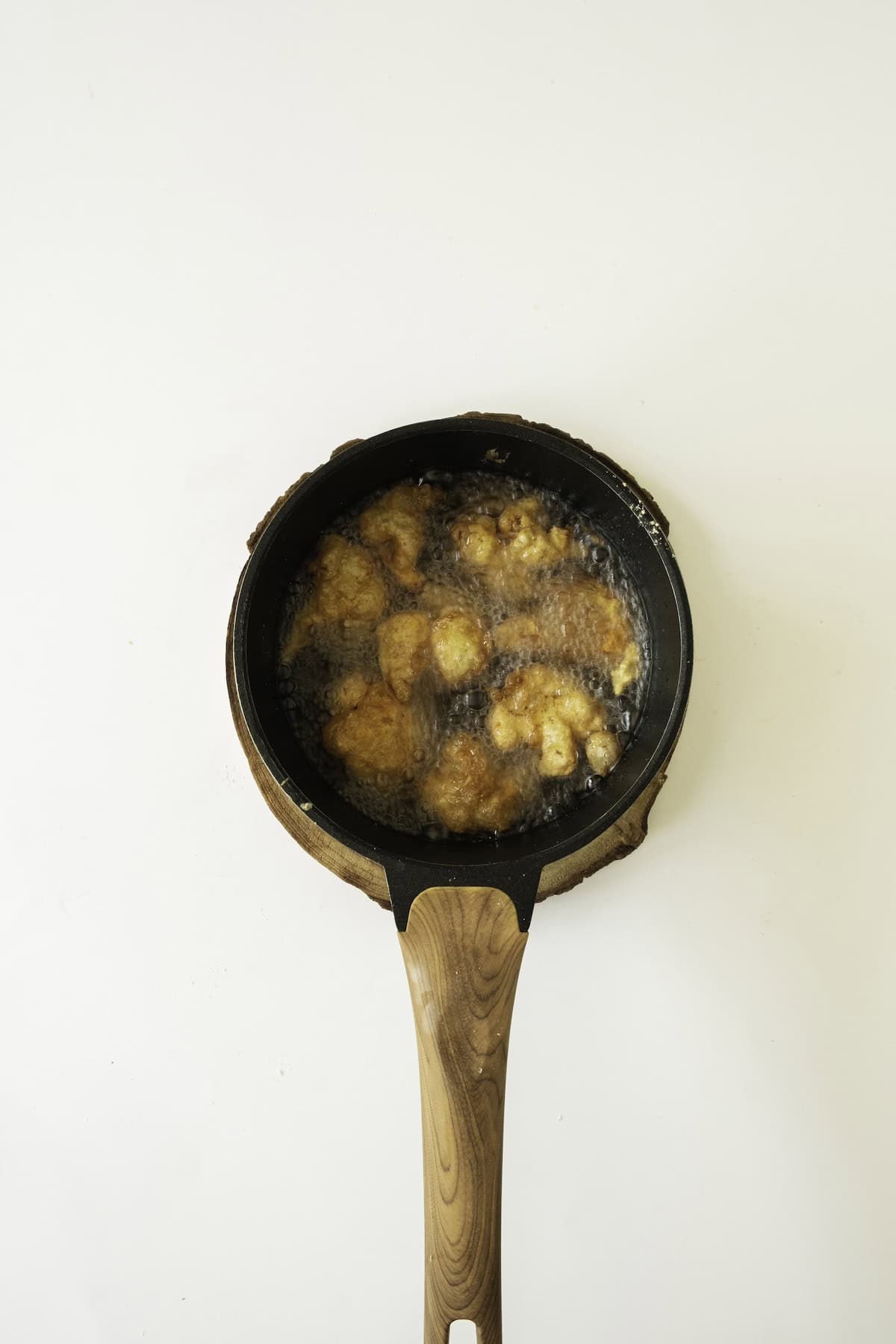 cauliflower bites frying in oil