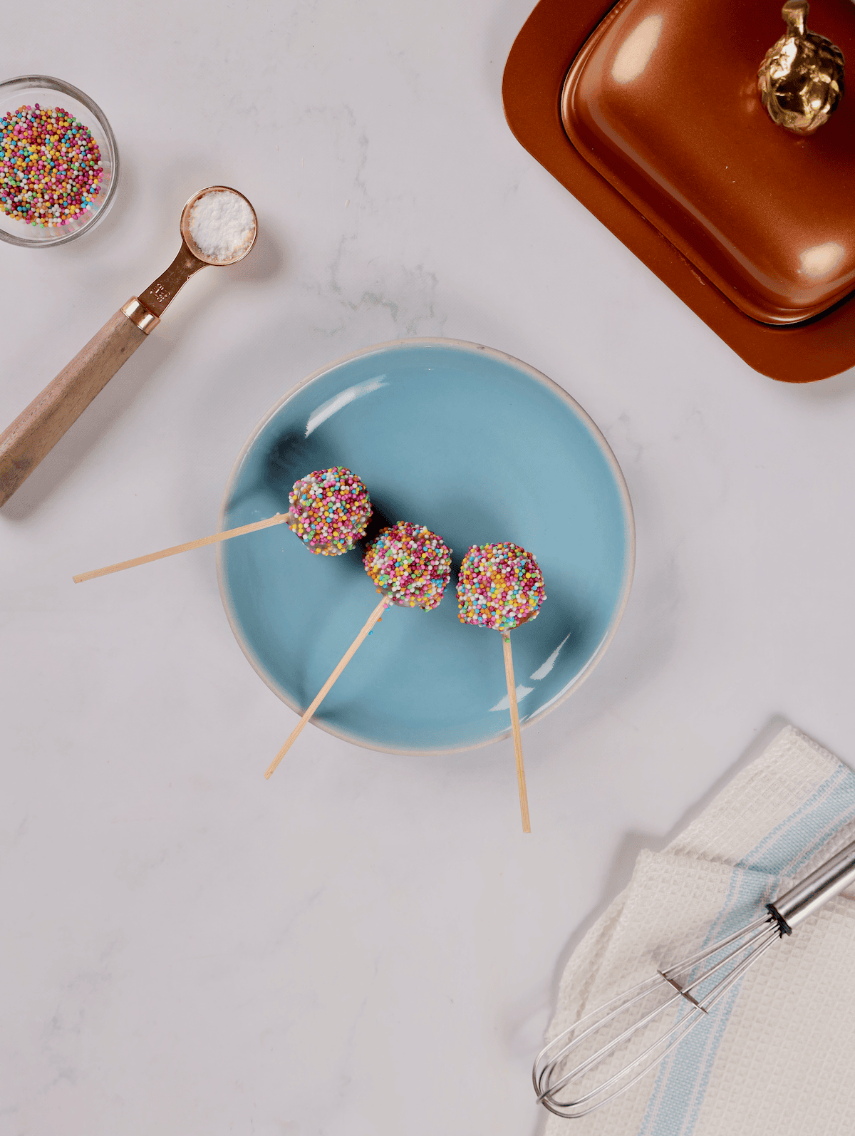 three cake pops on plate